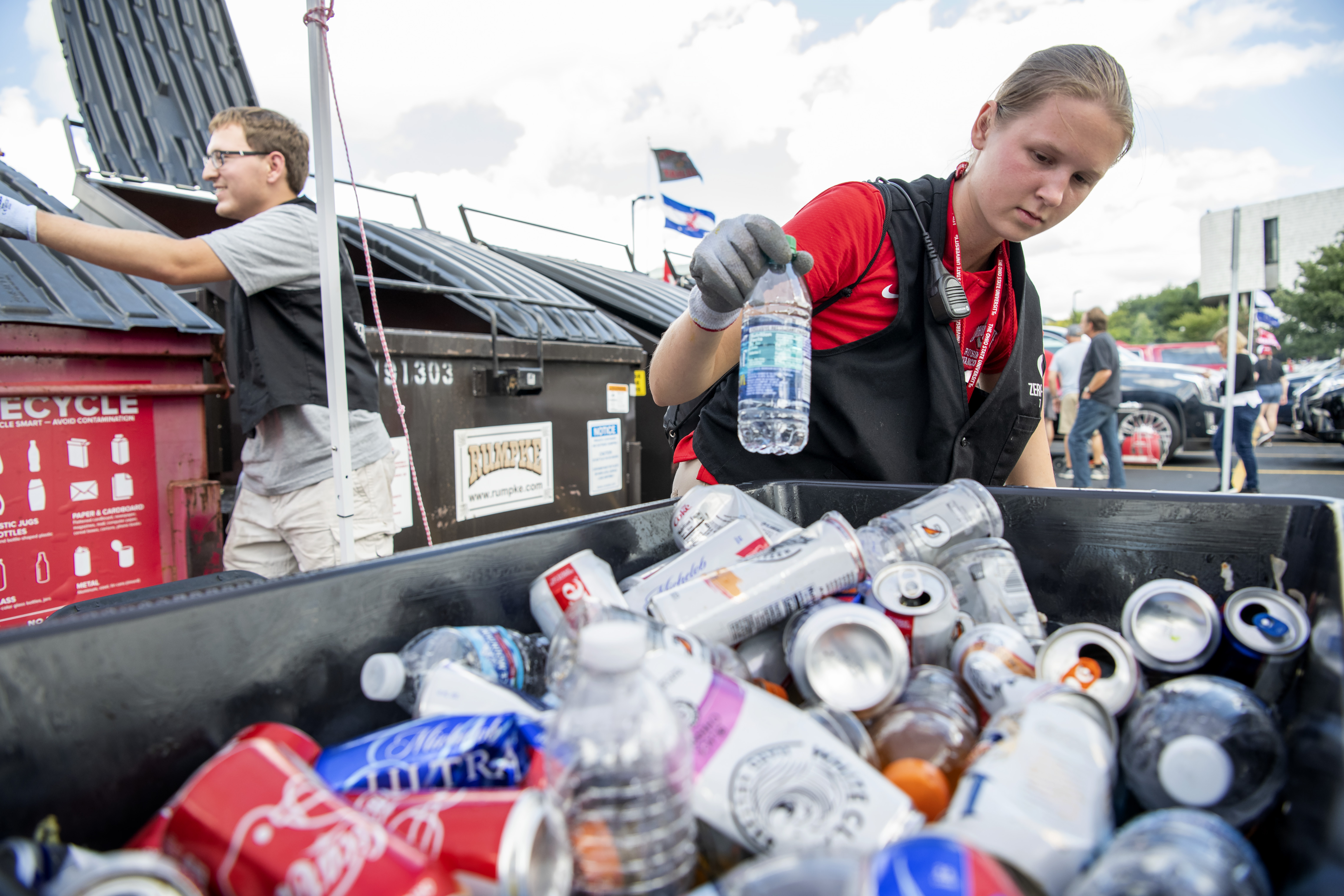 Melina Mallory sorting recycling after a home football game as part of Ohio State Zero Waste.