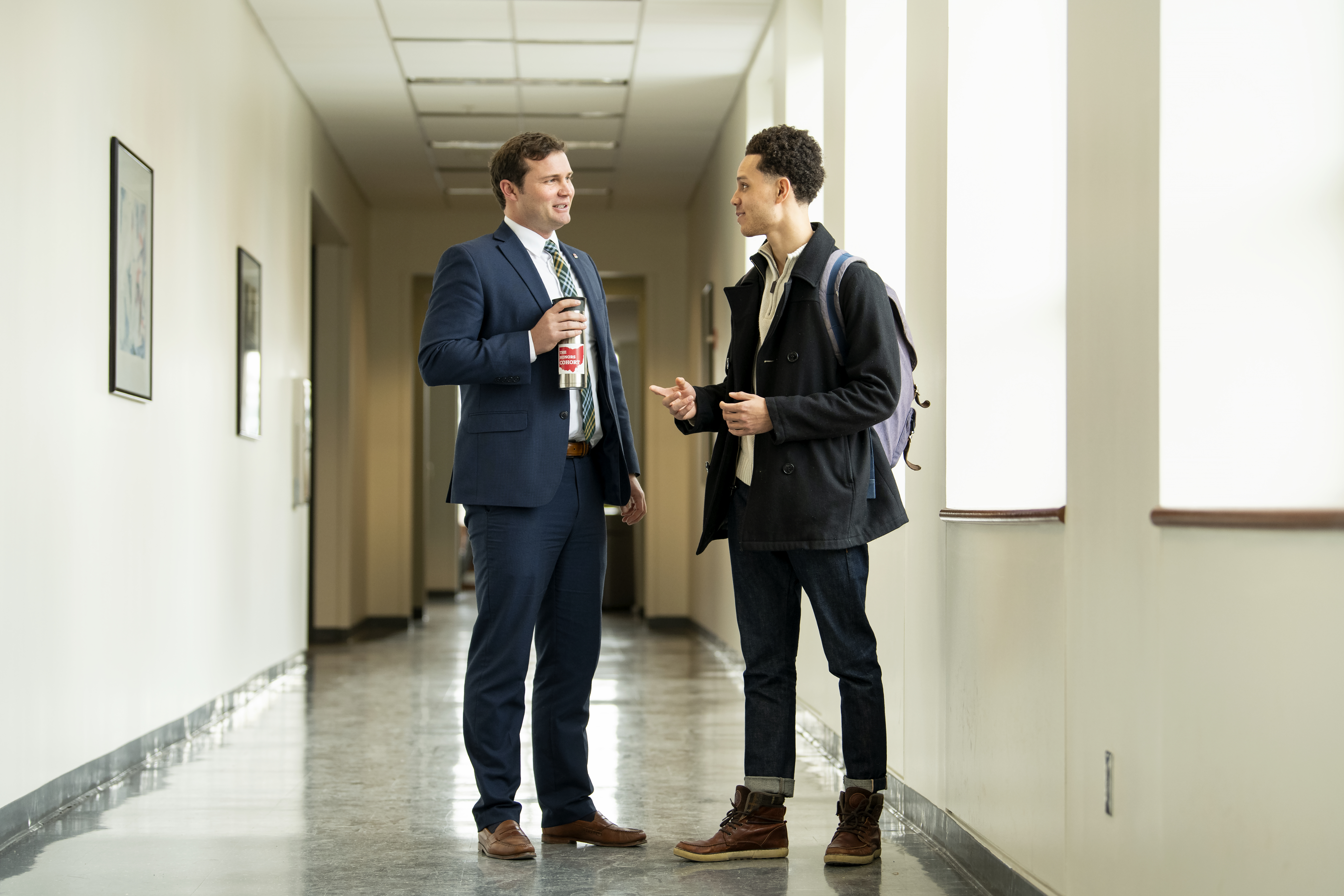 Faculty mentor and student conversing in the College of Business