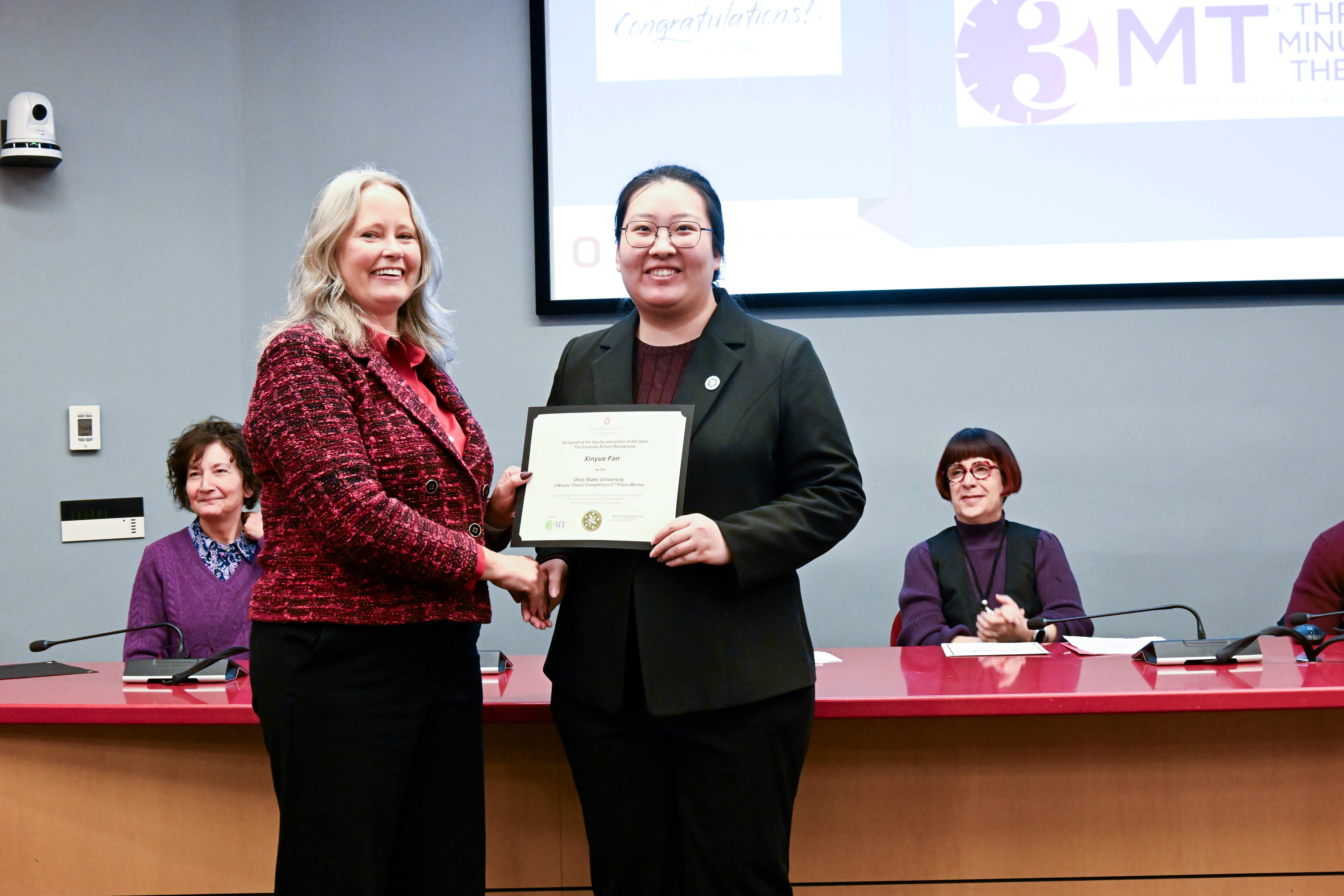 Mary Stromberger presenting Xinyue Fan with her certificate at the 2025 3mt