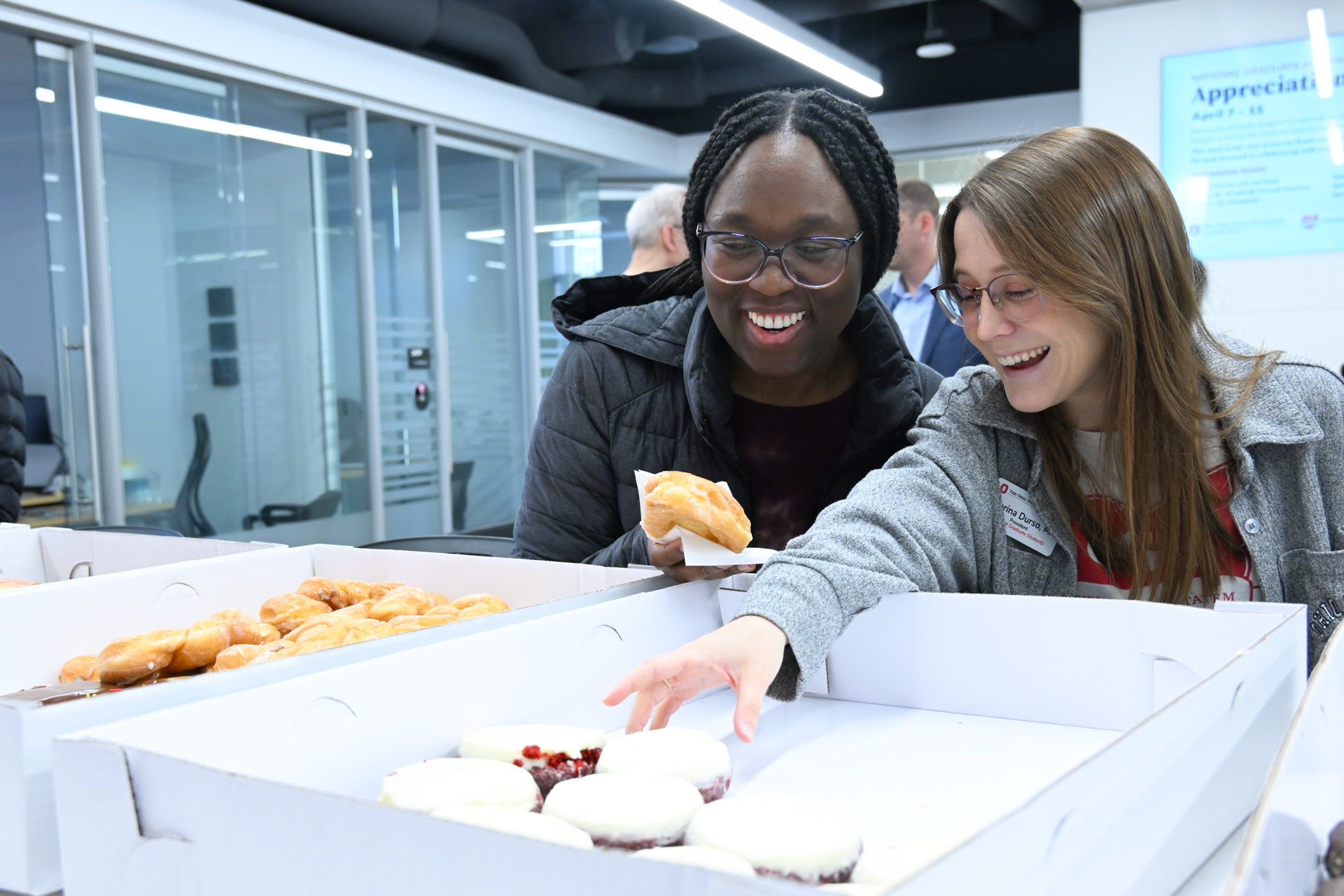 Council of Grad Students reps selecting donuts from a box