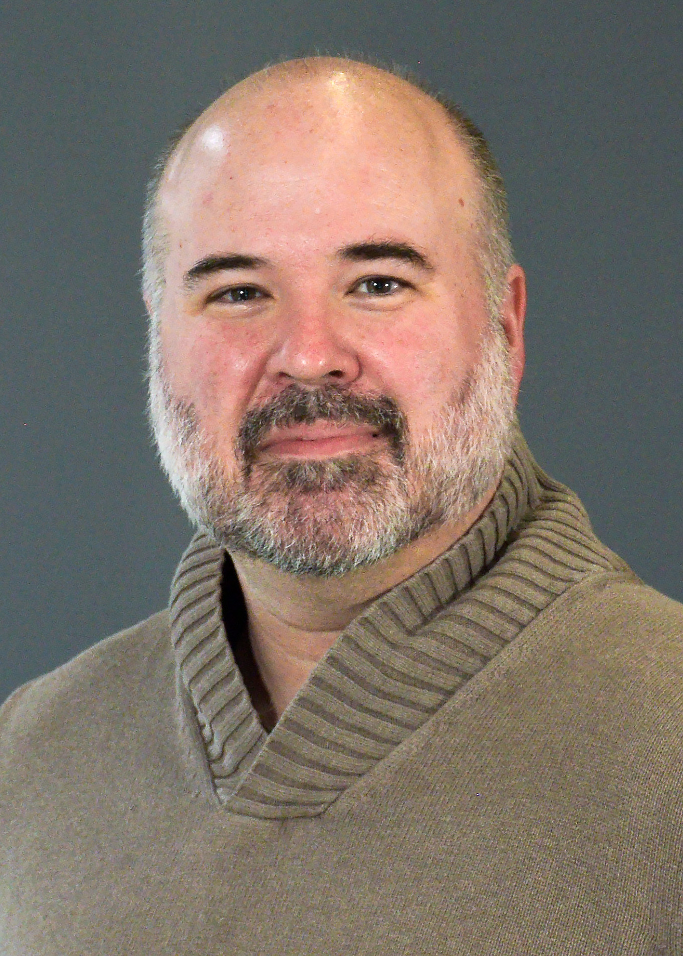 Portrait of Matt Swift in a brown sweater