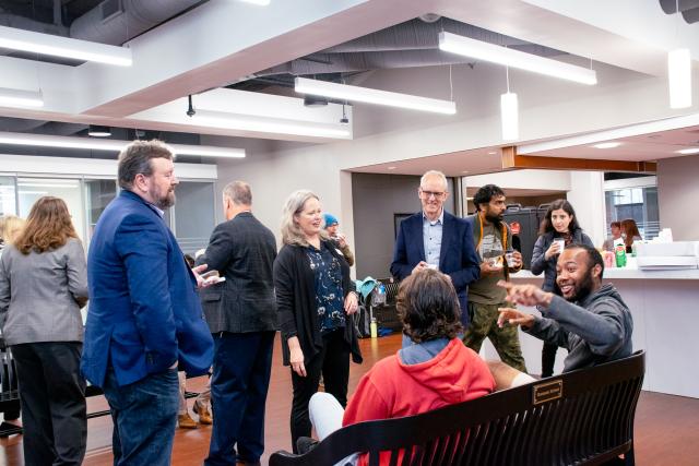 Graduate Students enjoying donuts and coffee