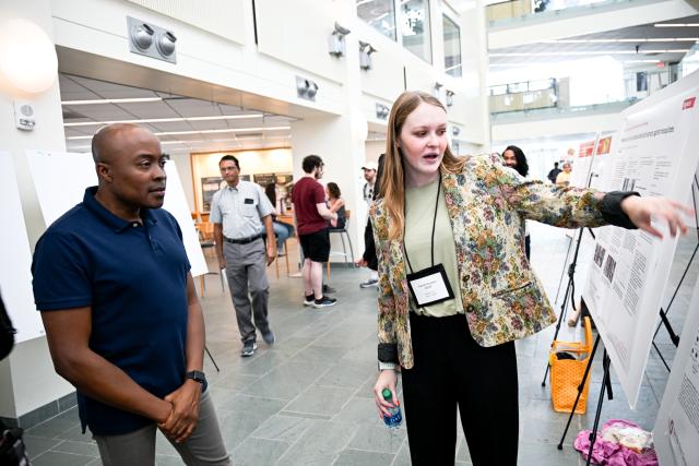 Stephen Quaye (left) listening to the presentation of Hannah Kemper (right) 