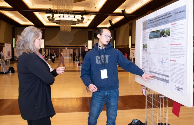Mary Stromberger, dean of the graduate school, interacting with a graduate student presenting their research on using water-based gardens to mitigate toxins.