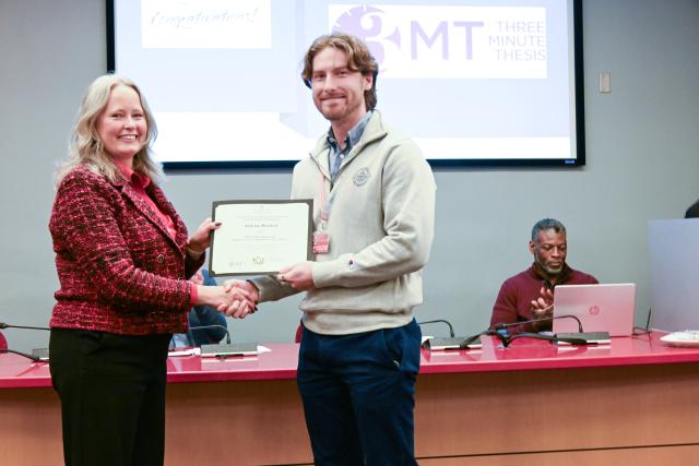 Mary Stromberger presenting Andrew Mitchell with his certificate at the 2025 3mt