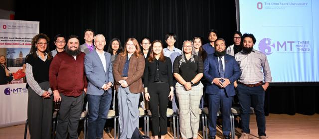 Group of 3mt participants in two rows on a stage 