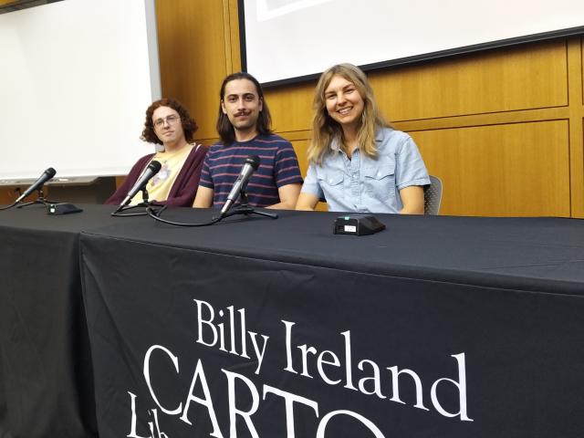 Three graduate students at a table at the Billy Ireland Cartoon Research Library