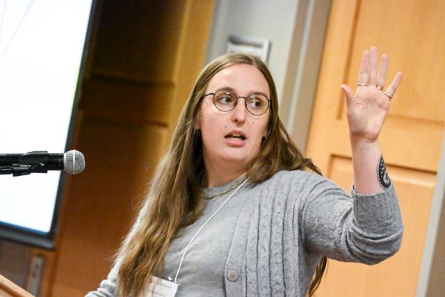 Neuroscience graduate student Amara Davis presenting behind a podium
