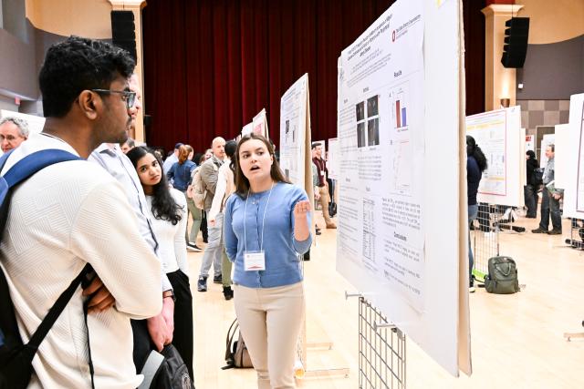 Biophysics graduate student Eleanor Rimmerman presenting to Biophysics graduate student Shubham Mulay