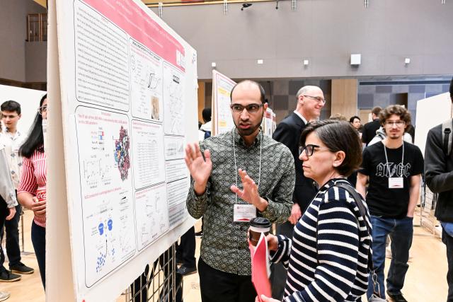 Biochemistry graduate student Fawwaz Naeem presenting to Natacha Ruiz, Professor, Microbiology