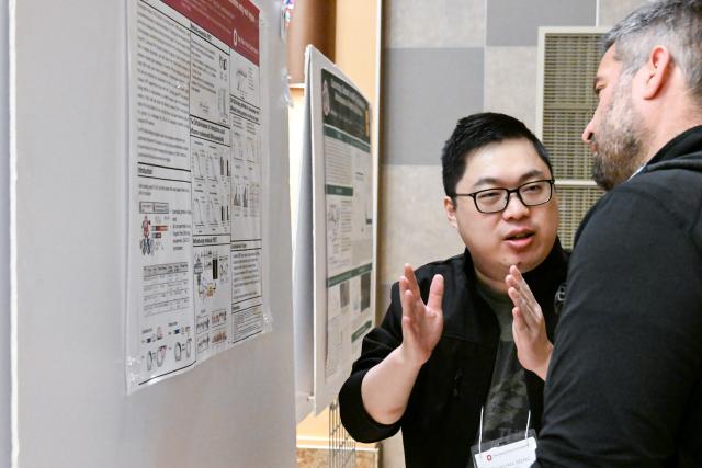 Biophysics graduate student Zhiyuan Meng presenting to Carlos Castro, Associate Professor, Mechanical and Aerospace Engineering
