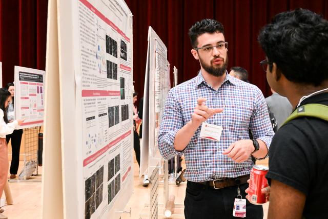Neuroscience graduate student Bryce Collison presenting to Premashis Manna, Assistant Professor, Chemistry and Biochemistry