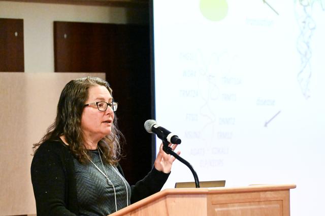 Jane Jackman, Professor, Chemistry and Biochemistry presenting behind a podium