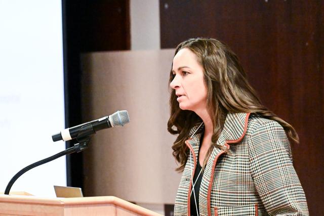 Allison Bradbury, Assistant Professor, Pediatrics presenting behind a podium