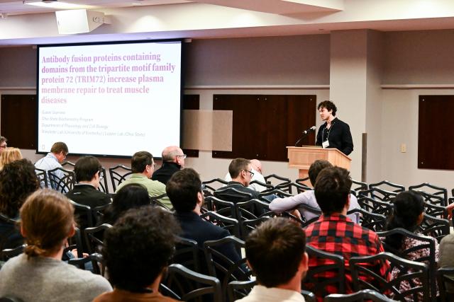 Biochemistry Graduate Program student Gianni Giarrano presenting in front of a crowd
