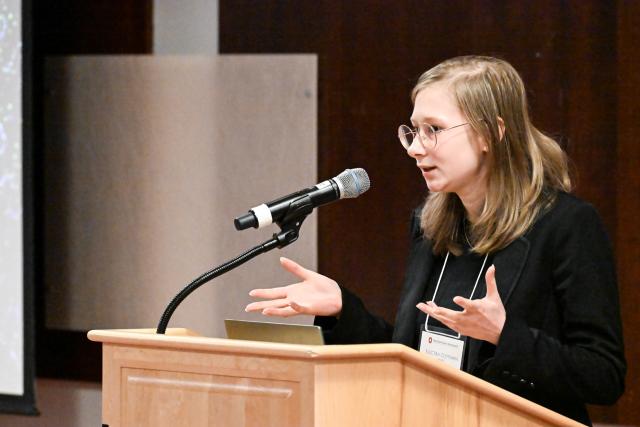 MCDB Graduate Program student Electra Coffman behind a podium