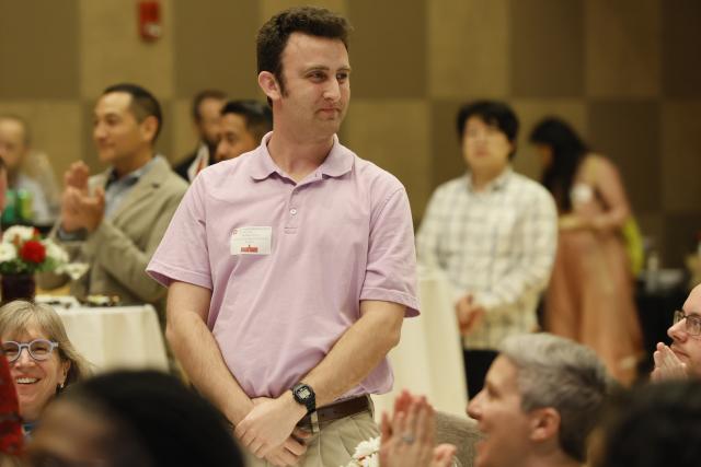 Graduate student standing to be recognized at the award ceremony