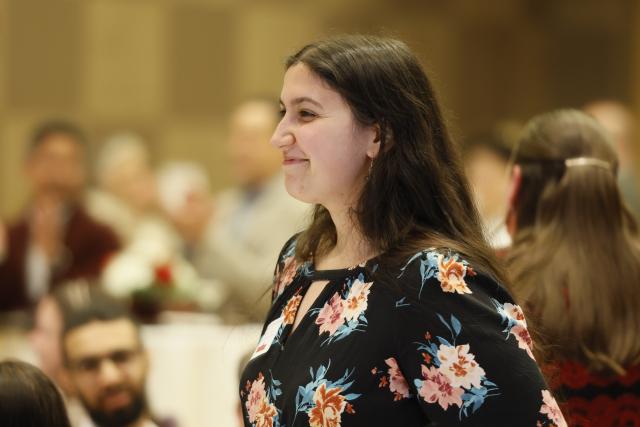 Graduate student standing to be recognized at the award ceremony