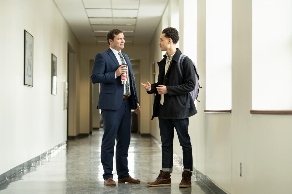 Faculty mentor and student conversing in the College of Business