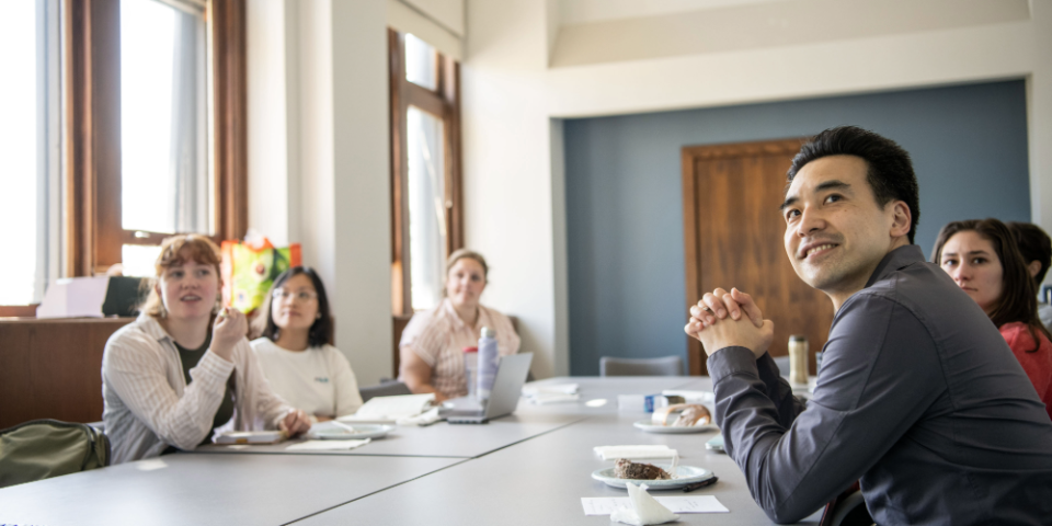Mentor meets with students around table