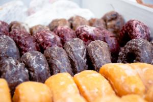 four varieties of glazed donuts in a box as part of the 2024 Donuts with the Deans event