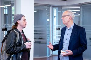 Dean Horn and a Graduate student conversing during the 2024 Donuts with the Deans event