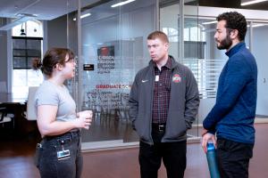 Katie Conner from the Council of Graduate Students speaking wityh another graduate Student and Ohio State Dean at the 2024 Donuts with the Deans event.