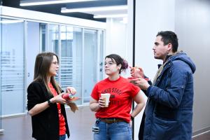 3 council of grad students reps enjoying pizza