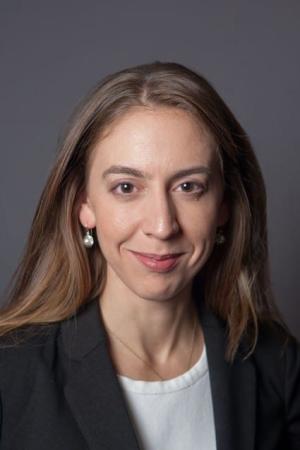 A photo of Randi Bates smiling wearing a black blazer and white blouse.