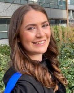 A photo of Hannah Budge smiling wearinga black dress.