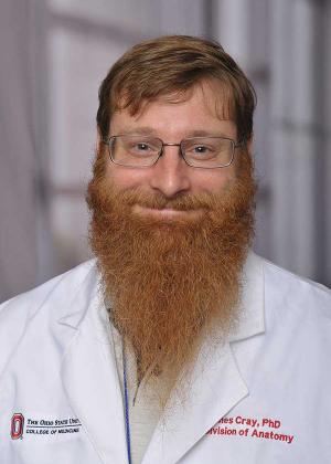 Dr. James Cray Jr. in a white lab coat