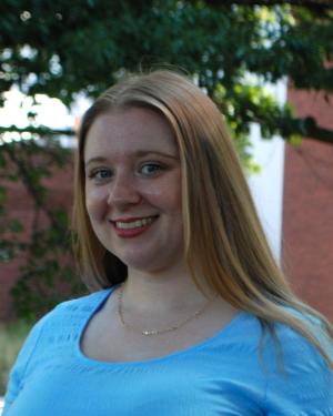 Portrait of Samantha Kirgesner in a blue shirt outside