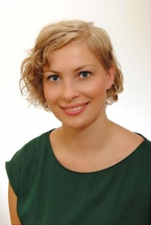 A photo of Katarzyna Danis-Wlodarczyk smiling wearing a green blouse.