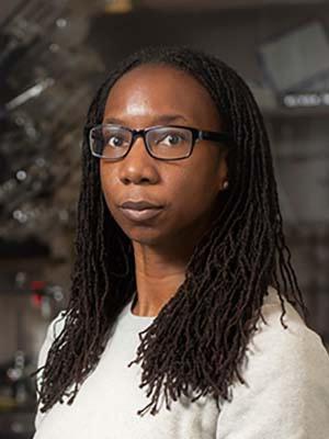 A picture of Davita Watkins wearing glasses and a white shirt
