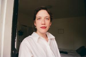 A photo of Ellen Feiss wearing a white dress shirt.