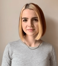 Shanna Hamilton smiling wearing a grey sweater.