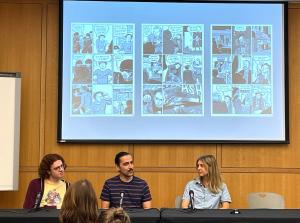 Three graduate students at a table presenting on specific comic book pages