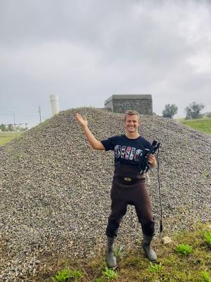 Joey Smith performing research in a field