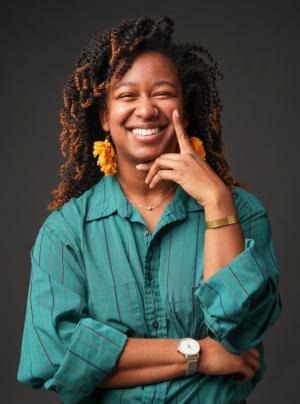 A photo of Megan Jordan wearing a blue-green blouse.
