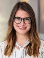 Sara Koenig, PhD in a white shirt and glasses