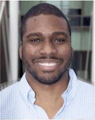 Allen Mallory smiling wearing a blue and white checkered dress shirt.