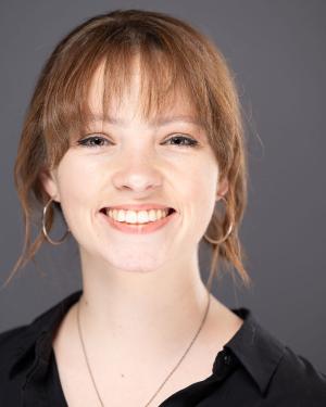 A photo of Alison Rickfelder smiling at the camera wearing a black blouse.