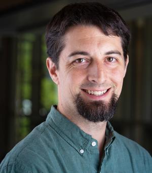 Robert Bauchmire portrait in a dark green shirt