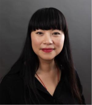 A photo of Van Truong smiling wearing a black blouse.
