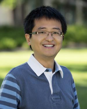 Yulong Xing in a two tones blue polo outside