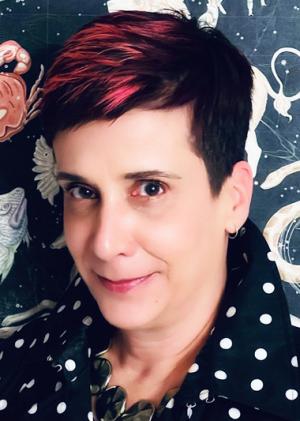 Dr. Isis Barra Costa in a black and white pock a dot shirt