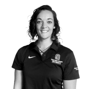 A black and white photo of Enora Le Flao smiling at the camera wearing a polo shirt.