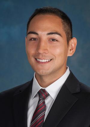 Dr. Marc Guerrero in a black suit