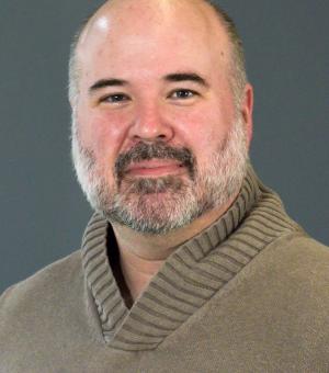 Portrait of Matt Swift in a brown sweater